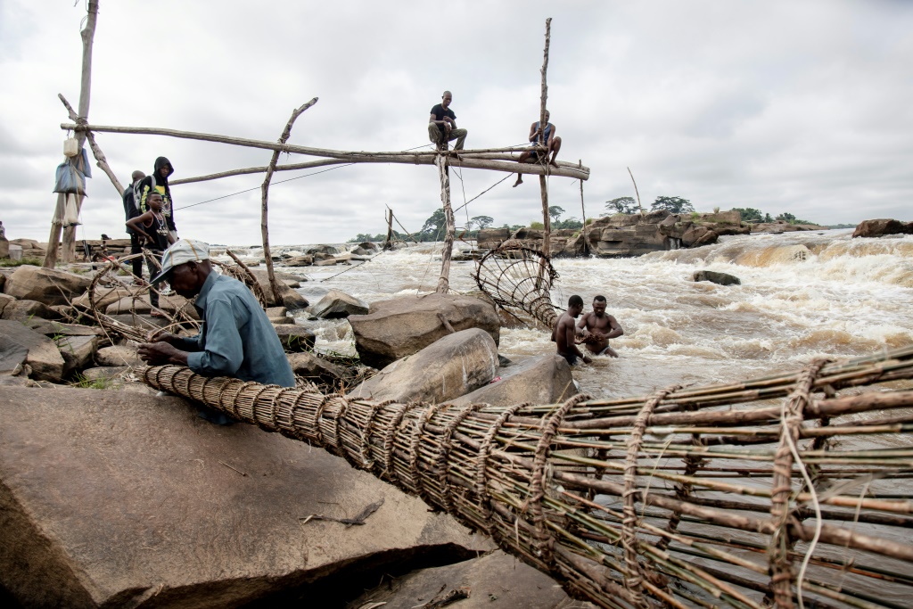 Fishermen perch on wooden scaffolds at the Wagenya Falls in ortheastern DR Congo