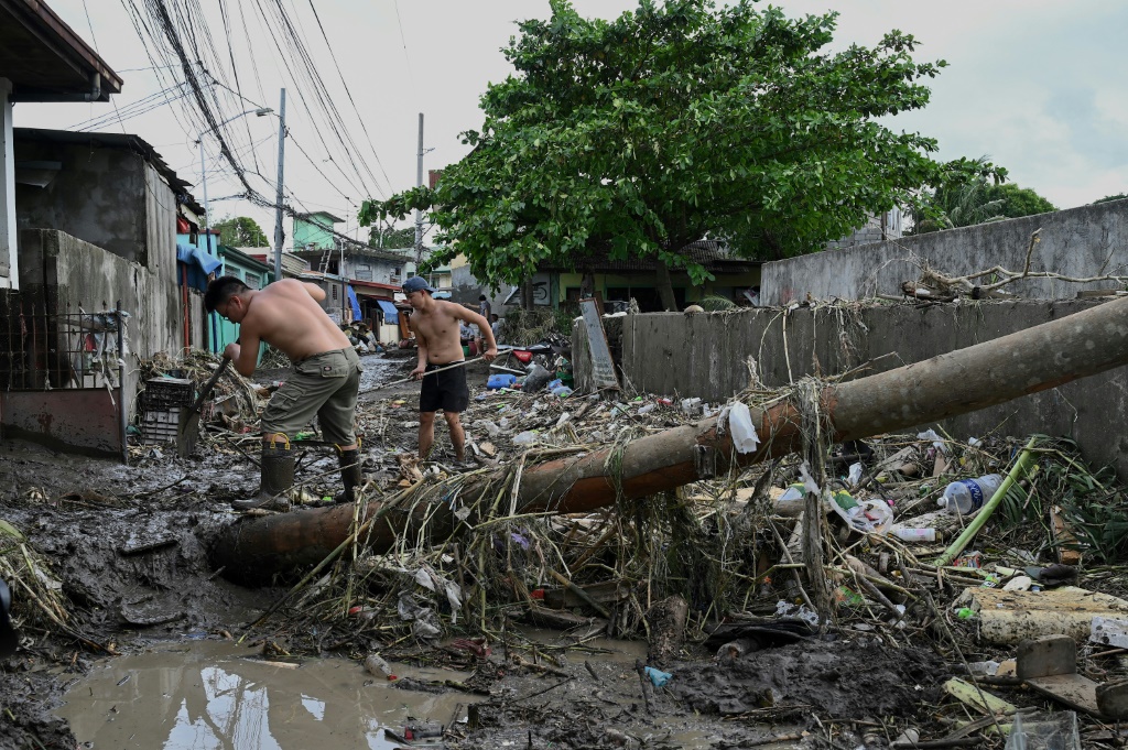The death toll from floods and landslides unleashed by a tropical storm in the Philippiones jumps sharply to 98