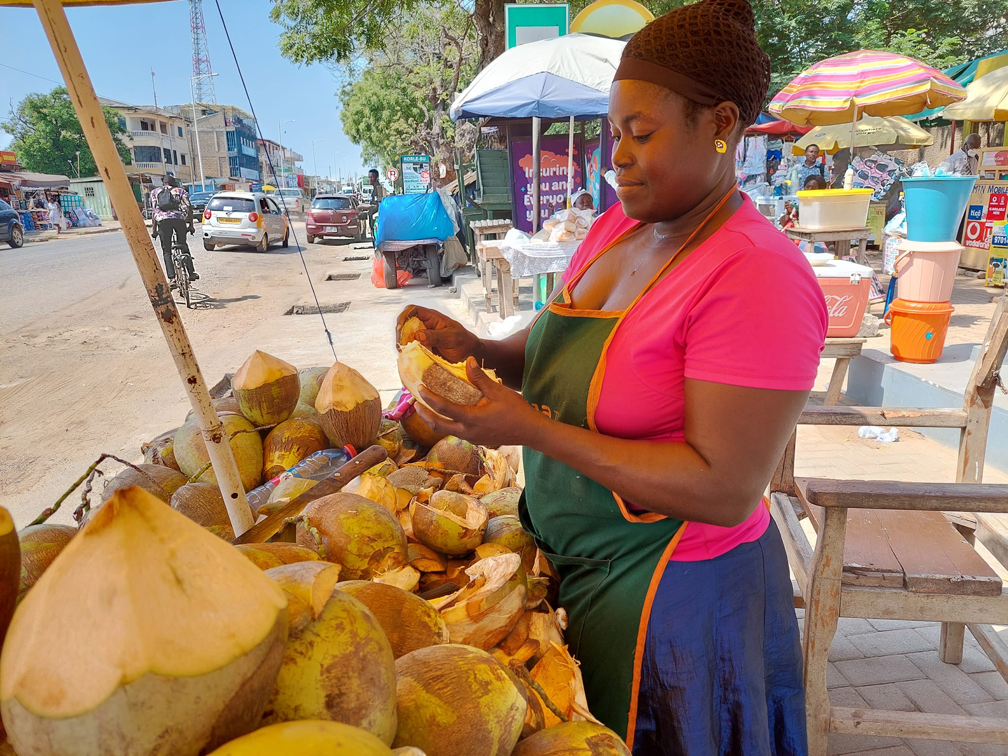 Ghanaian female coconut vendor.