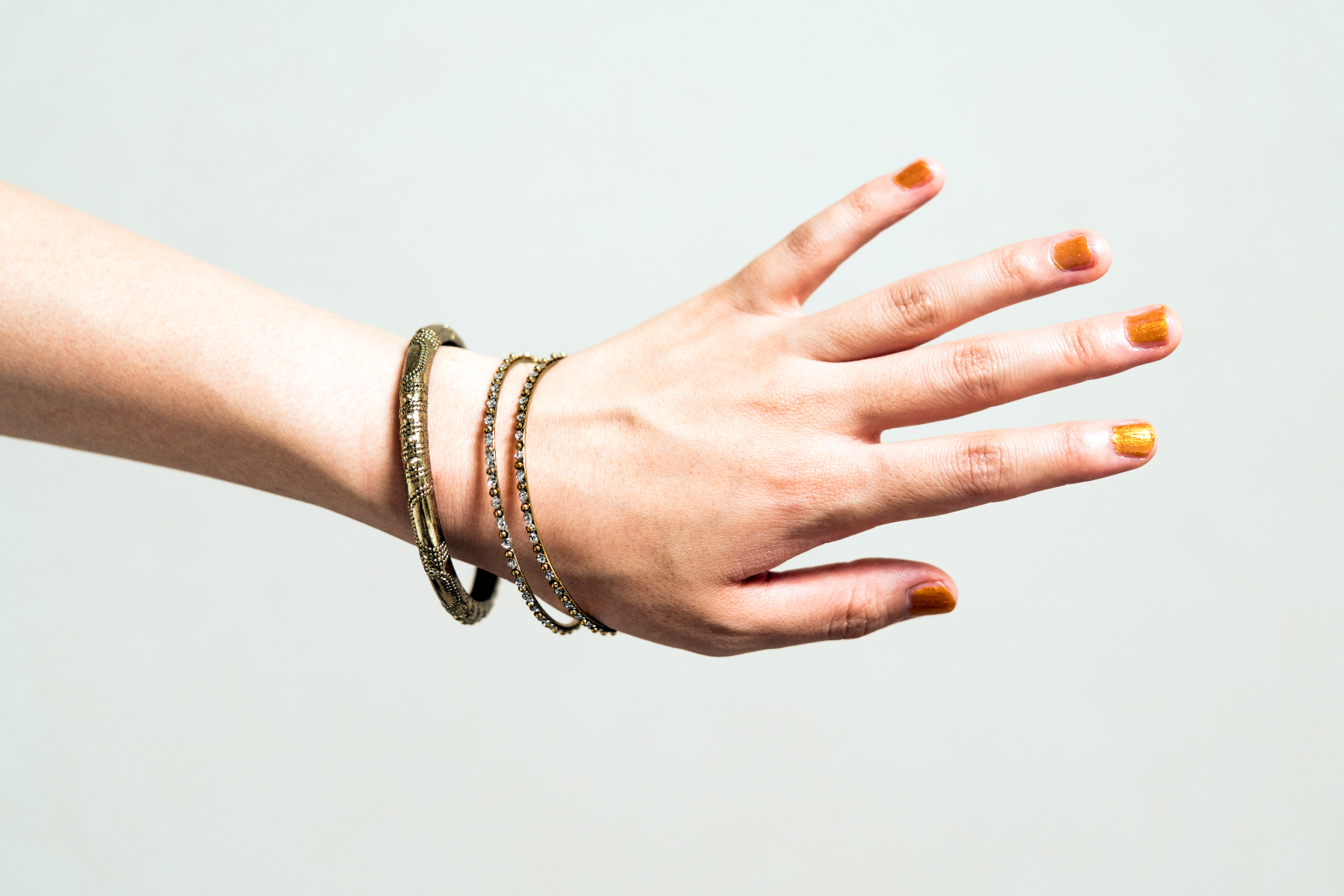 A lady's hand with gold bangles