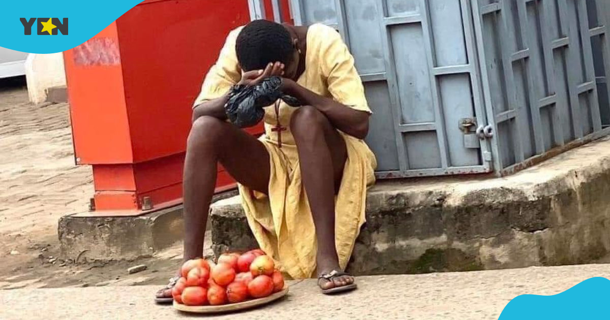 Tired hawker girl resting by road with scanty tomatoes on her plate and cross around her neck makes many sad