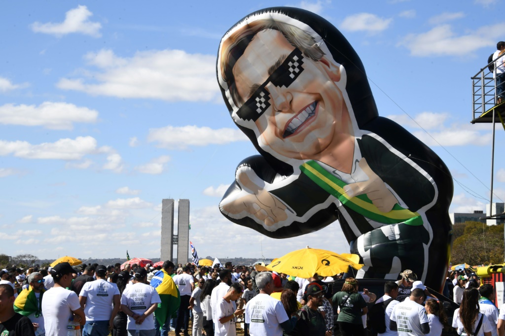 An inflatable Bolsonaro floats over a gun-rights rally in Brasilia.
