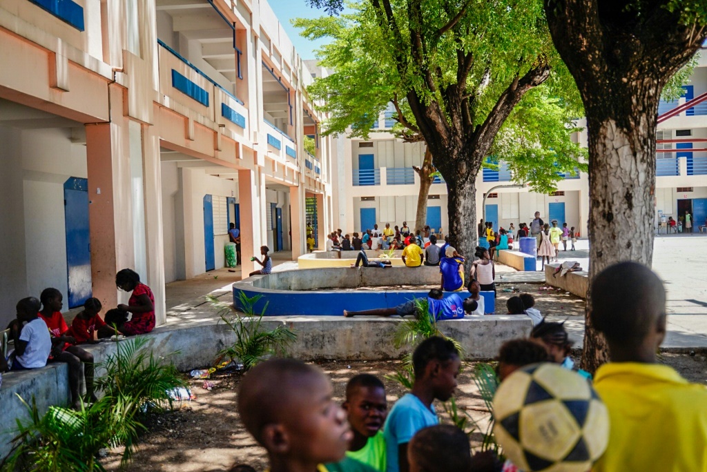 Haitian children play games to forget the horrors they have seen, after religious groups managed to negotiate their evacuation from conflict area, mostly without their parents