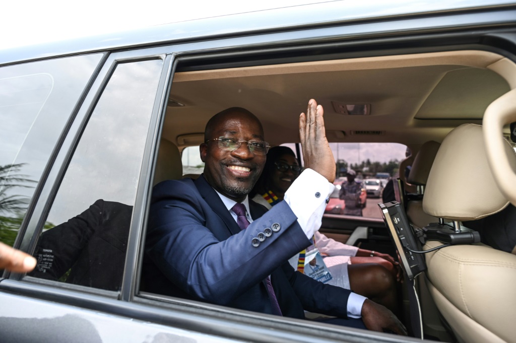 Wearing a suit and tie, the 50-year-old landed at the airport in the economic hub of Abidjan