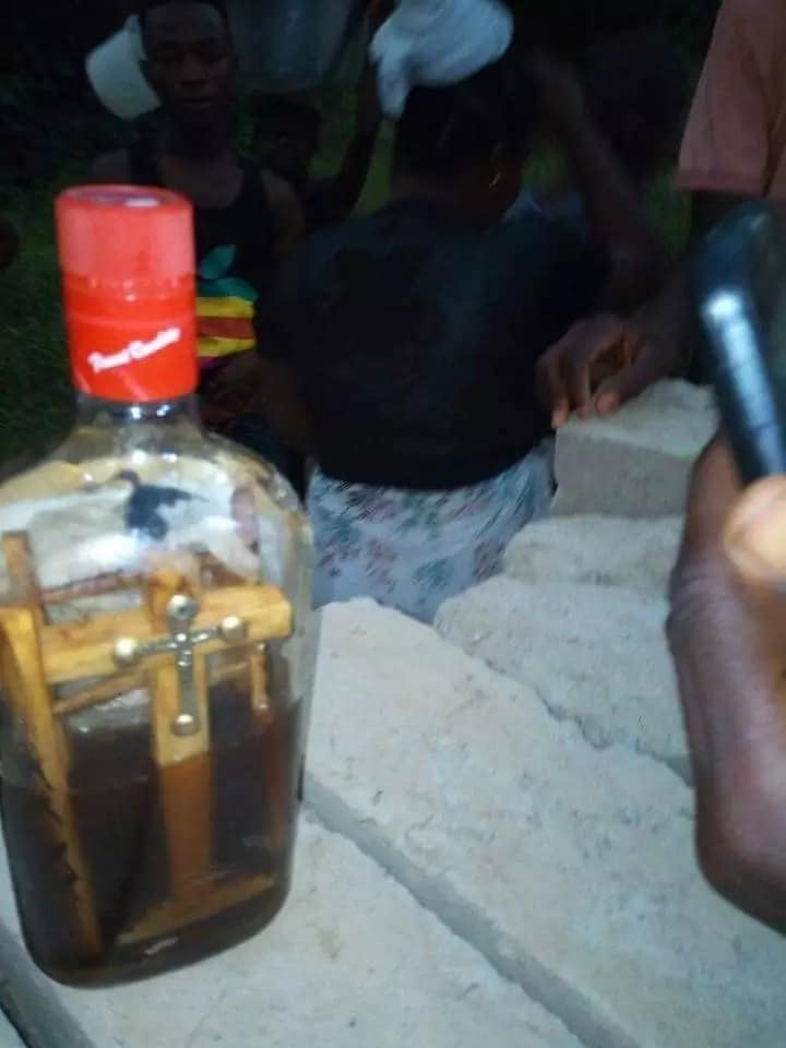 This bottle with crucifix and picture was found floating on the Bonsa river at Tarkwa
