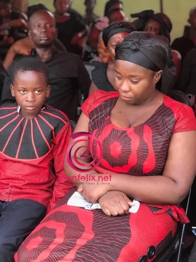 Actress Maame Serwaa in a somber state sitting next to her younger brother