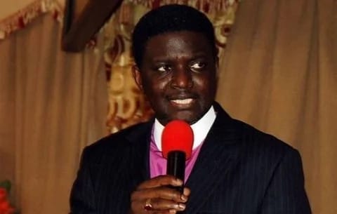 Bishop Agyin-Asare holding a microphone