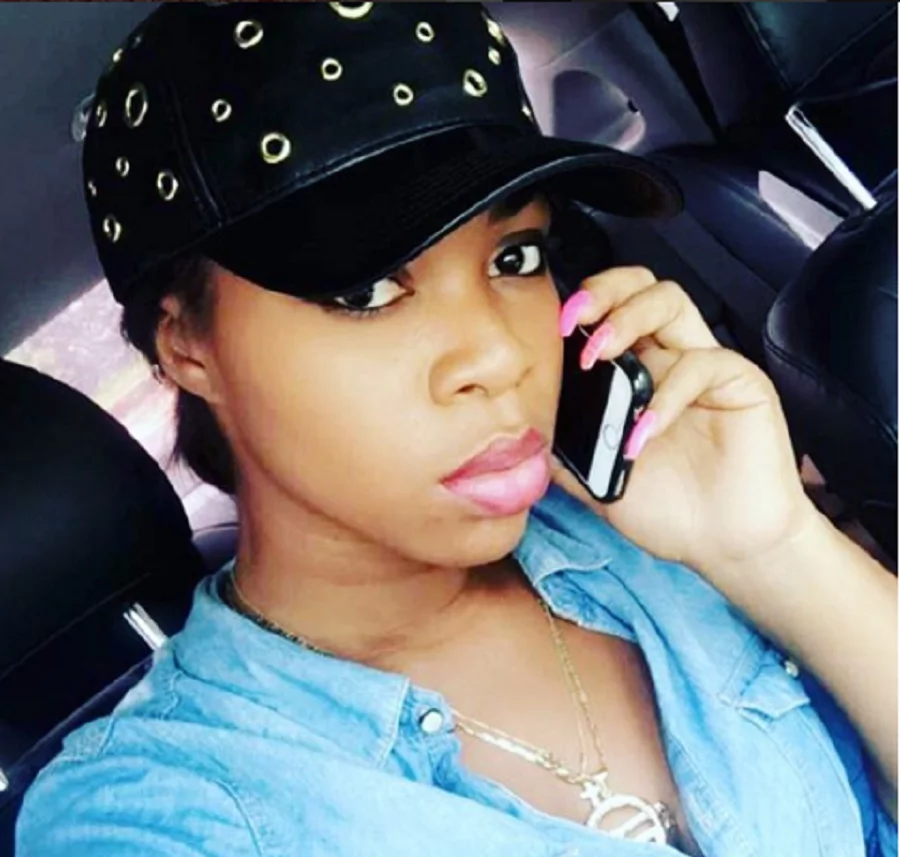 Shatta Michy holding a cell phone