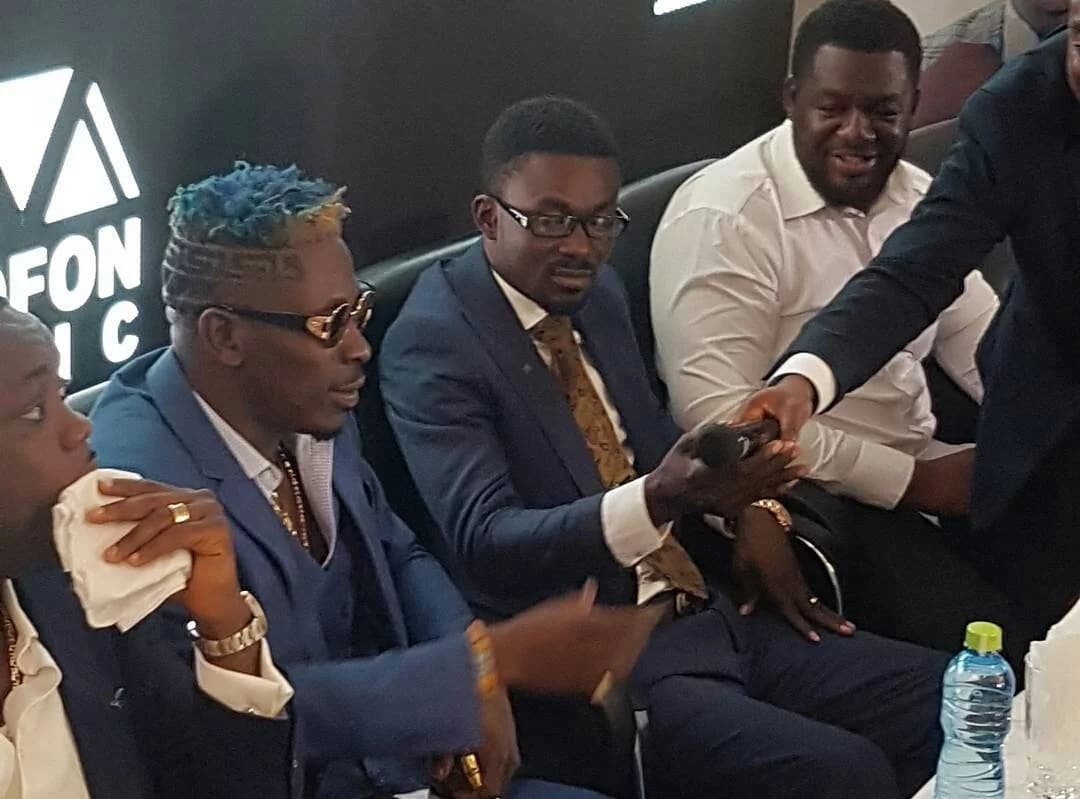 Shatta Wale sits with Zylofon boss, Nana Appiah Mensah and Bulldog (in white) at the unveiling ceremony on Wednesday