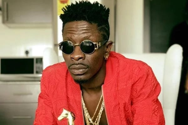 Shatta Wale in a red dress