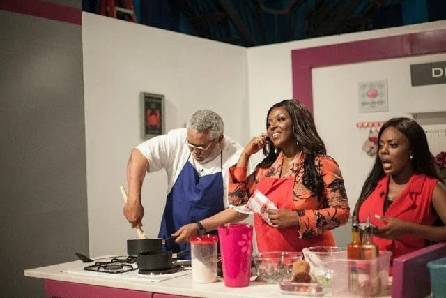 J.J Rawlings with Nana Aba Anamoah and Yvonne Okoro on a cooking set