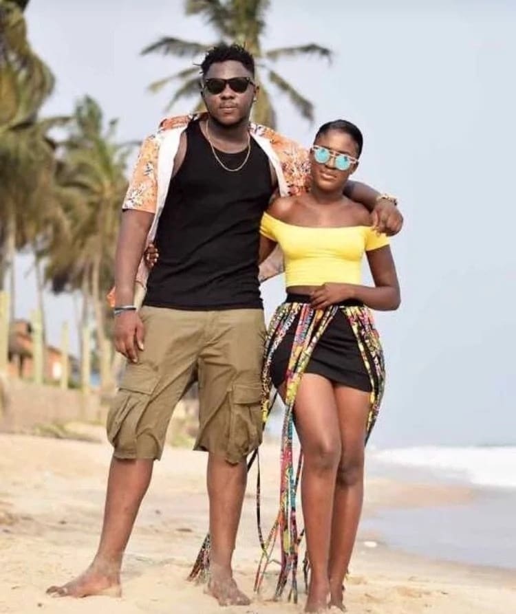 Ghanaian man and woman stand together on a beach