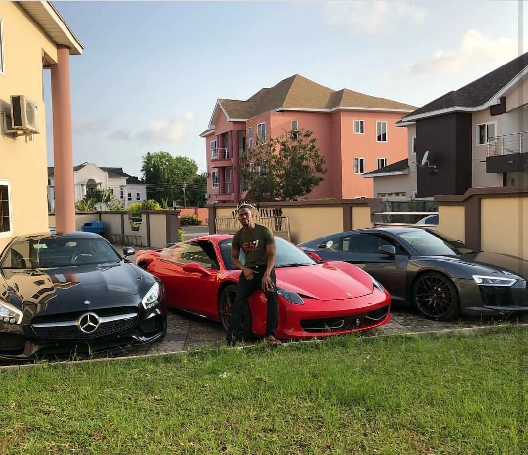 A man posing with 3 cars