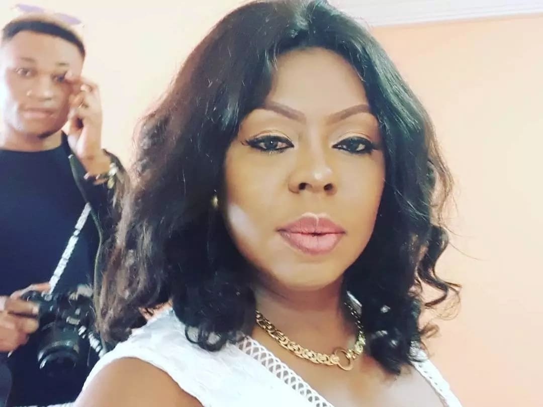 Afia Schwarzenegger takes a photo with a man holding a camera behind her