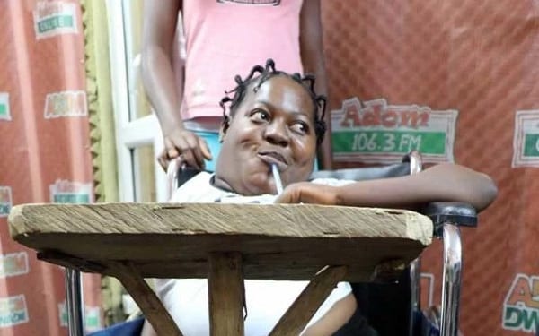 Girl writes BECE exam with pen in mouth