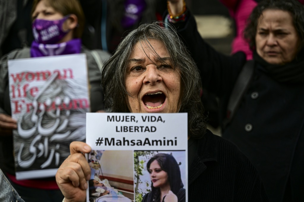 A woman holds a picture of Amini during a demonstration in Santiago, Chile