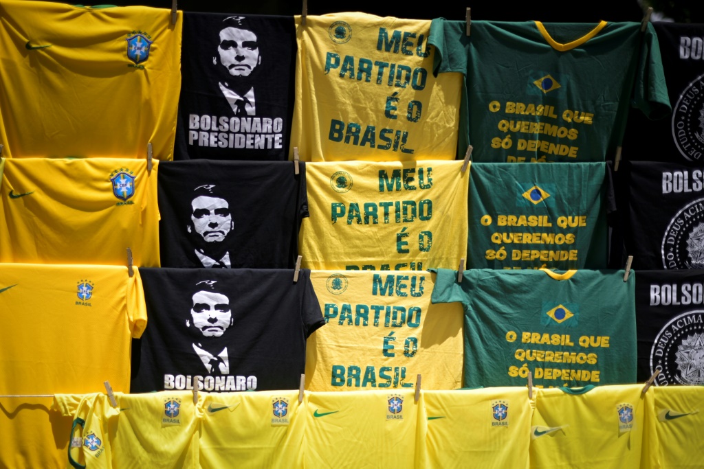 Brazil jerseys on sale alongside pro-Bolsonaro T-shirts, many in the yellow and green of the flag