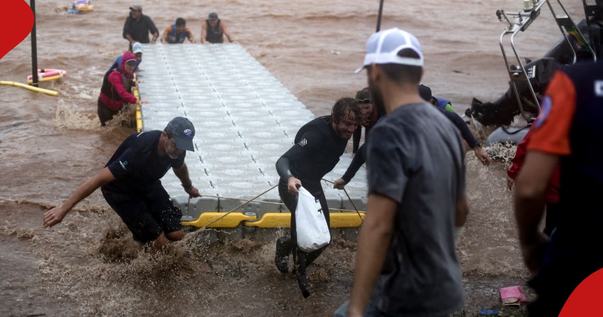 Volunteers take back equipment from Lake Guaiba as a storm brews in Porto Alegre, Rio Grande do Sul state, Brazil, on May 8, 2024.