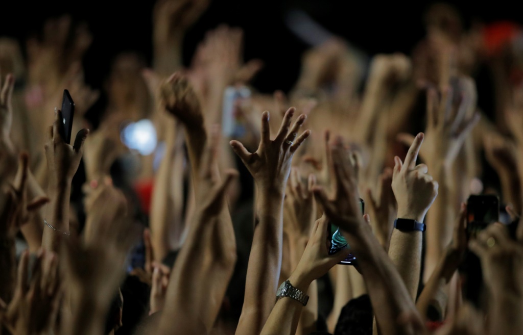 Supporters of Brazilian president-elect Luiz Inacio Lula da Silva in Sao Paulo raise their hands in celebration after the run-off election on October 30