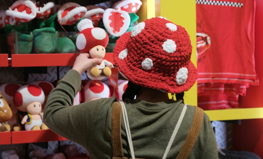A guest looks at a Toad toy in a store during a preview of Super Nintendo World in Los Angeles