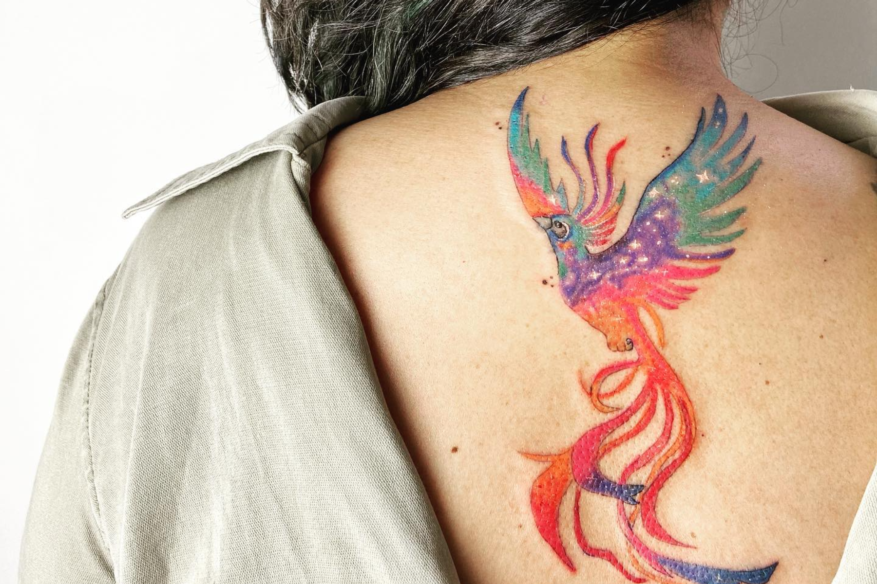 Colorful Phoenix tattoo located on the upper arm,