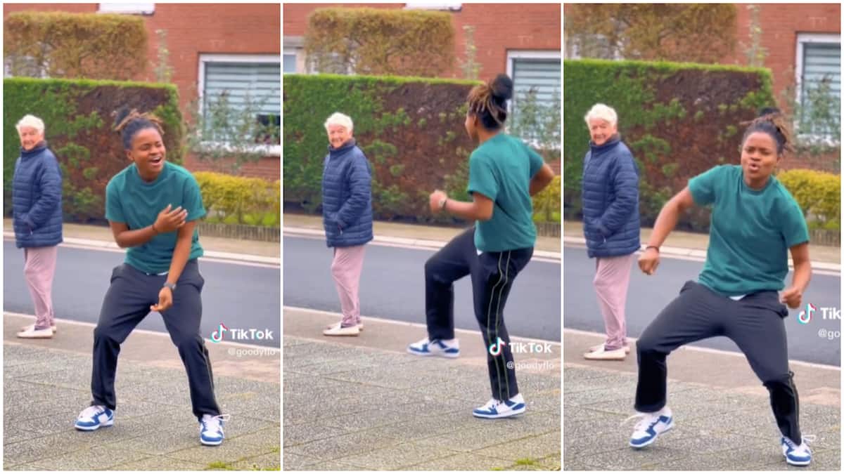 Nigerian lady entertained passerby/old woman watch lady dancing.