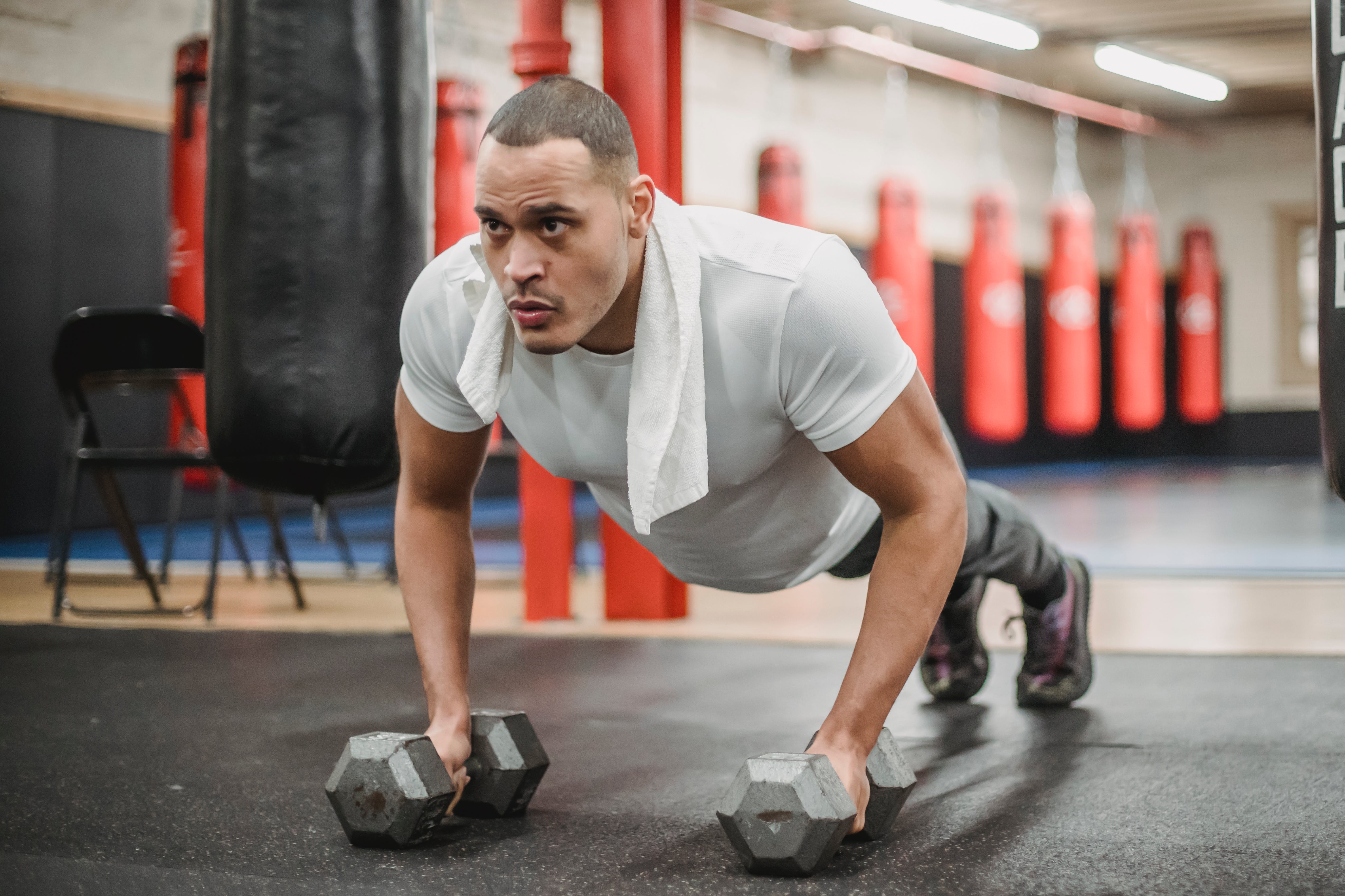 A man doing push ups with dumbbells