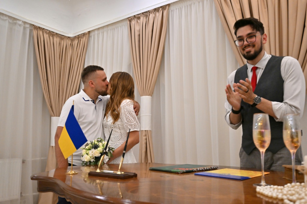 Vitaliy Charnykh has been conducting back-to-back ceremonies at a registry office in Kyiv as couples dash to marry amid the uncertainty of war