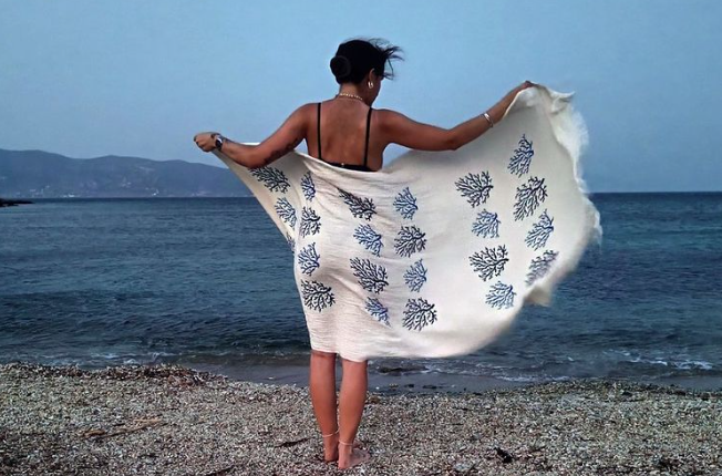 A woman holding a beach towel