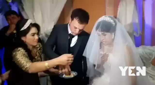 Groom slaps bride for teasing him.with food at their wedding (video)