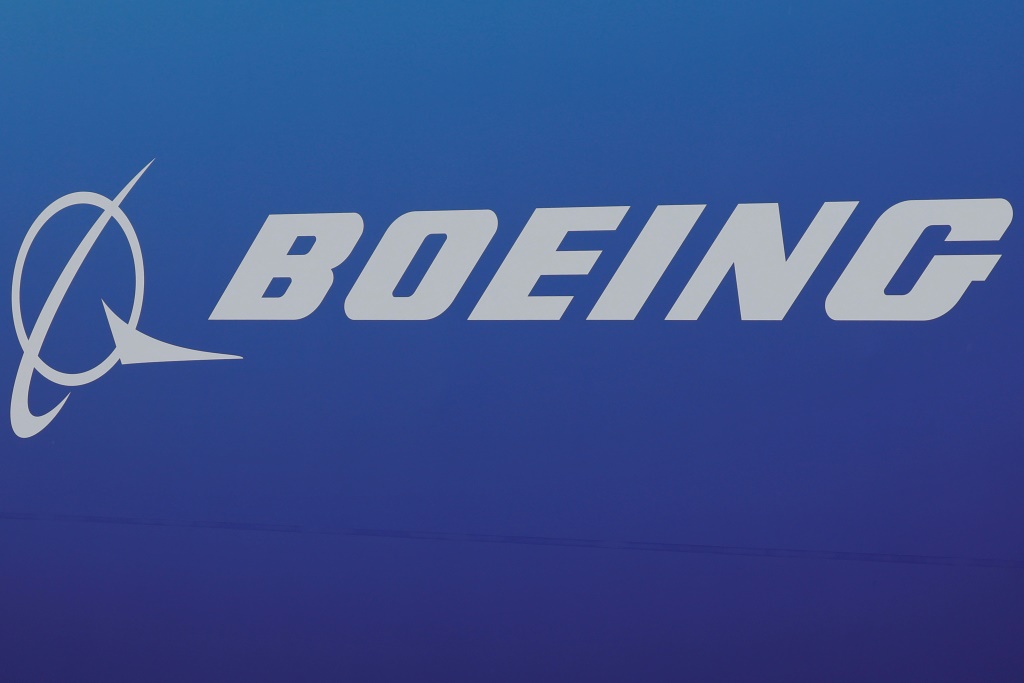 Boeing reported a quarterly loss but lifted production rates on key commercial plane models