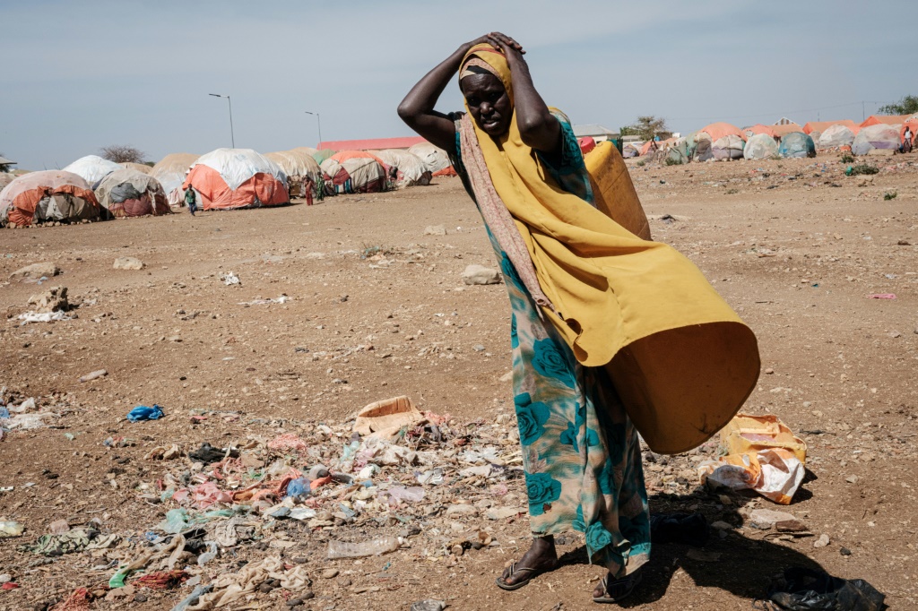 A woman carries a water container at a camp for internally displaced persons in Somalia, which has received insufficient rainfall since late 2020