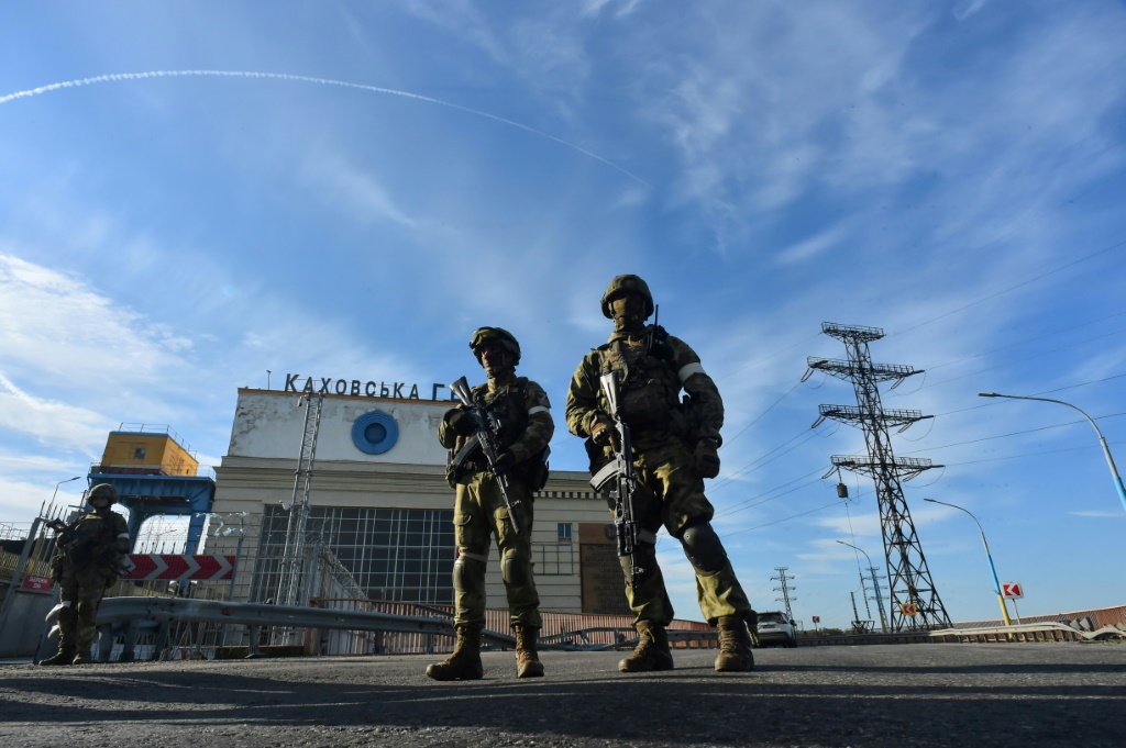 Russians patrol in May at the Kakhovka Hydroelectric Power Plant, which Kyiv says Russian forces plan to blow up, triggering a devastating flood
