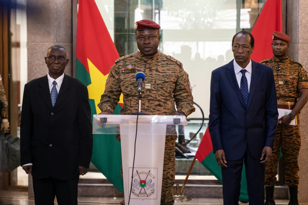 Burkina Faso junta leader Lieutenant-Colonel Paul-Henri Sandaogo Damiba (C) has taken over the role of defence minister as well