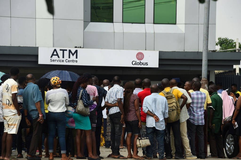 Many Nigerians have been queueing for hours outside ATMs to try and get cash after a redesign of the local currency