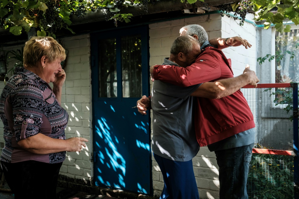Ukrainians in the eastern village of Troitske reunite after the area was recaptured following a months-long occupation by Russia's army