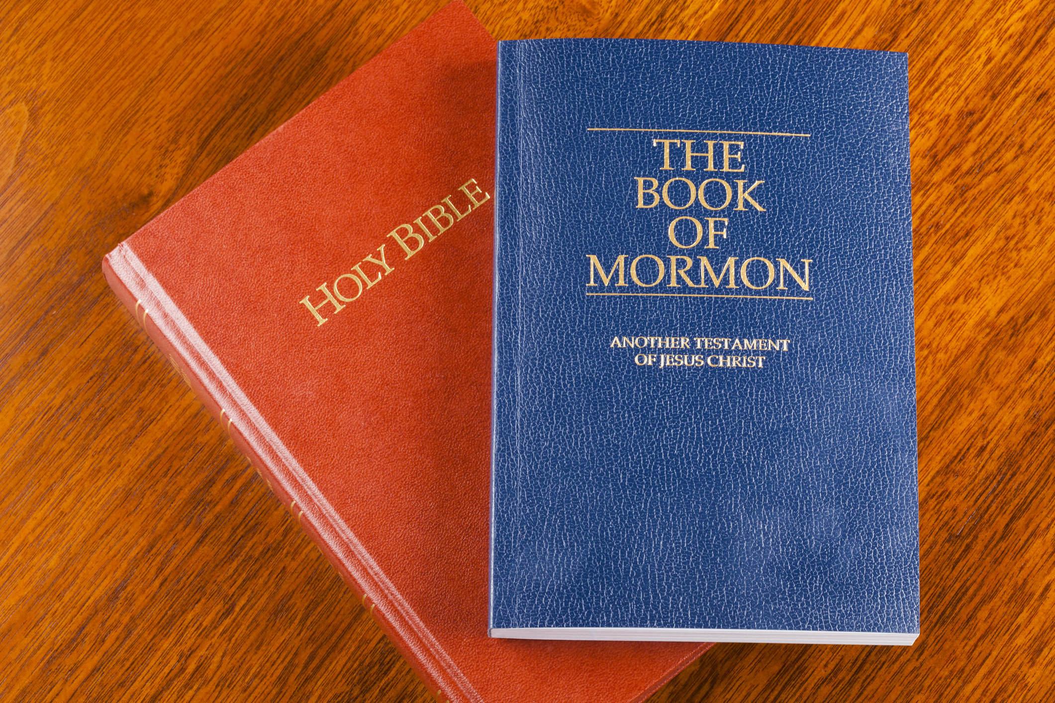 The Book of Mormon and Catholic Bible on a table.