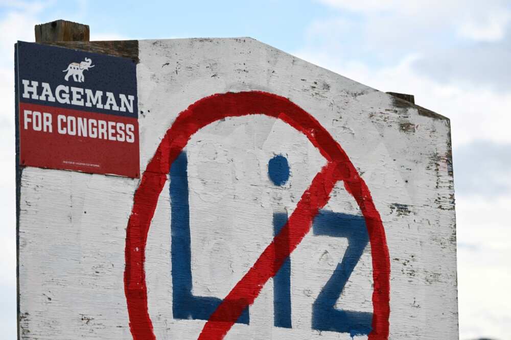 A hand painted sign stands in opposition to US Representative Liz Cheney (R-WY) displayed on the side of a road along with support of her Republican primary opponent Harriet Hageman in Casper, Wyoming