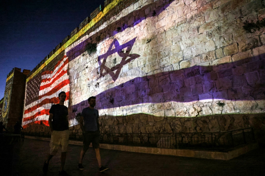 The Israeli and US flags are projected against the wall of Jerusalem's Old City during the visit by US President Joe Biden, who will meet with Israeli and Palestinian leaders before flying onwards to Saudi Arabia