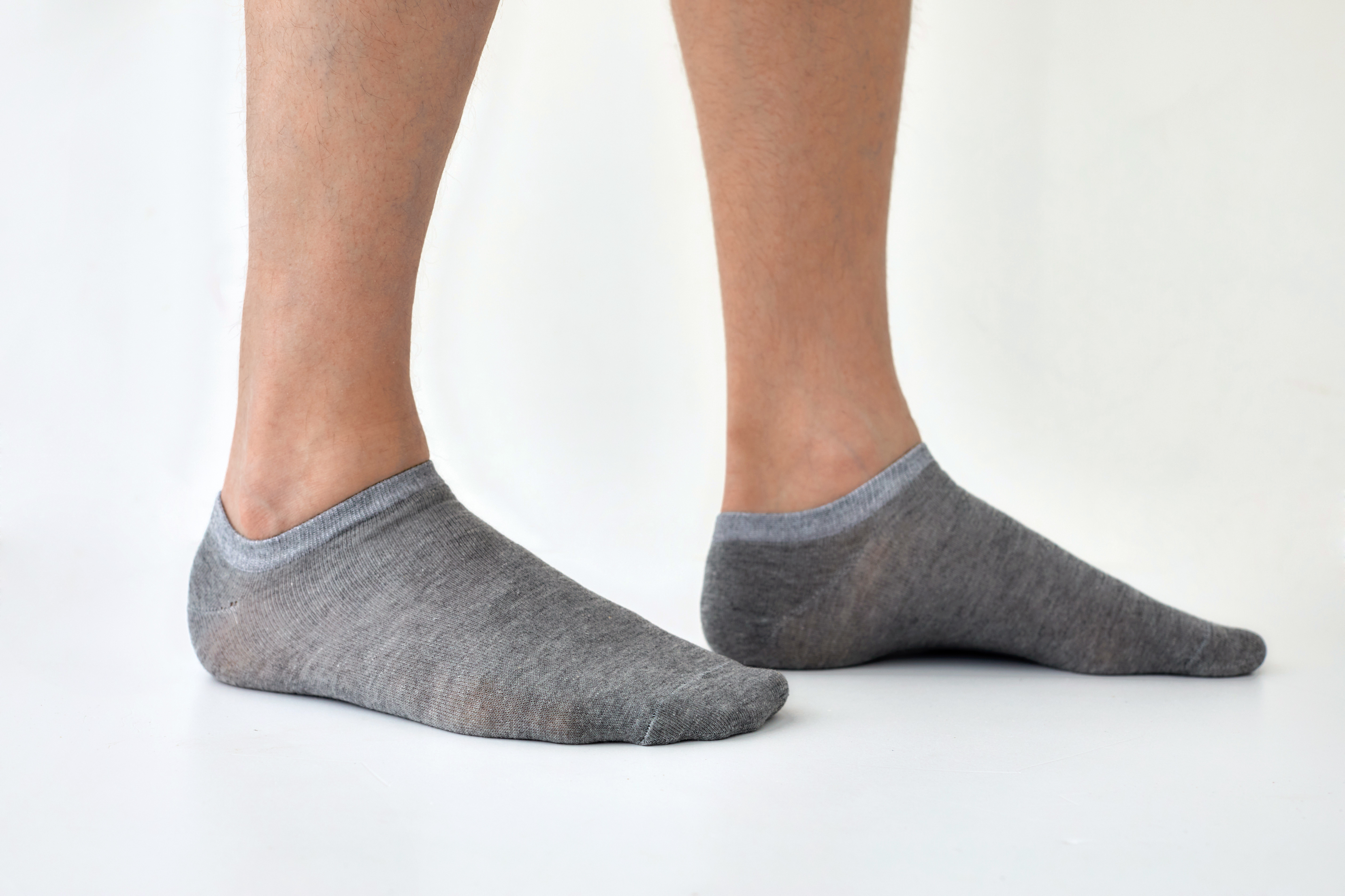 A person with grey ankle socks