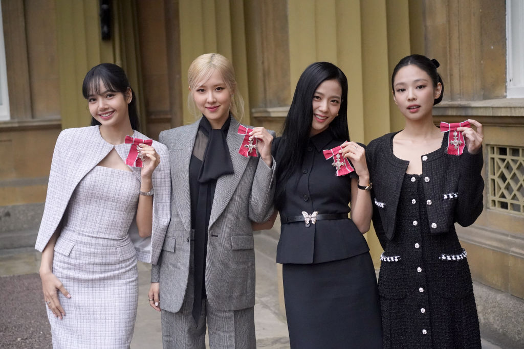 From left to right, Lisa, Rose, Jisoo Kim, and Jennie Kim from the K-pop band Blackpink pose with their Honorary MBEs.