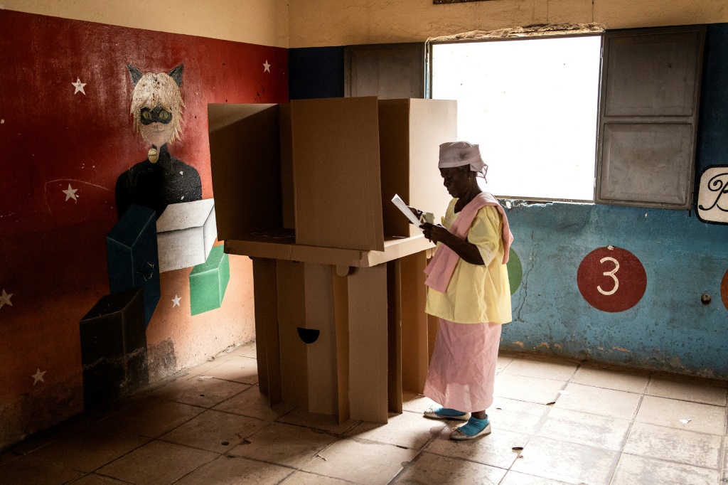 Angolans started casting ballots on August 24, 2022 in what is expected to be the most competitive vote in its democratic history, with incumbent president Joao Lourenco squaring up against charismatic opposition leader Adalberto Costa Junior. A woman folds her ballot paper at a voting booth in Luanda on August 24, 2022, during Angola's general elections.