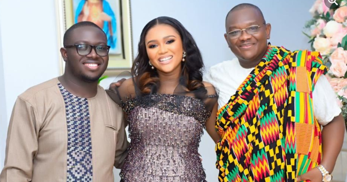 Yvonne poses alongside her father and hubby in a photo
