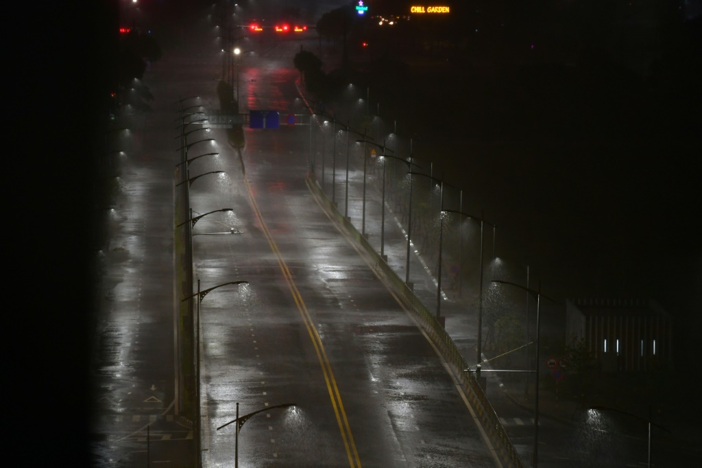 Heavy rain from Typhoon Noru falls on an empty road in Danang, in central Vietnam where the storm made landfall before dawn on September 28, 2022