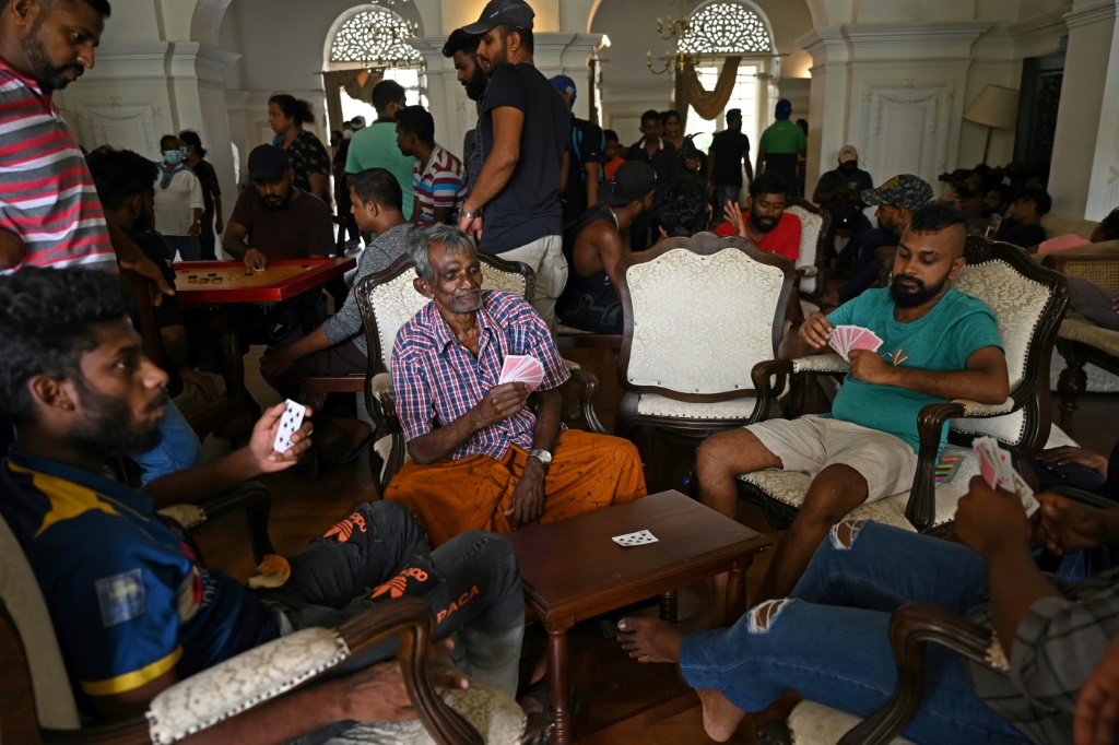 People play cards inside the official residence of Sri Lanka's Prime Minister a day after it was overrun by anti-government protestors