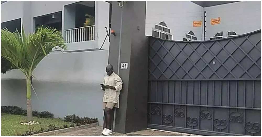Stephen Appiah poses in front of his mansion