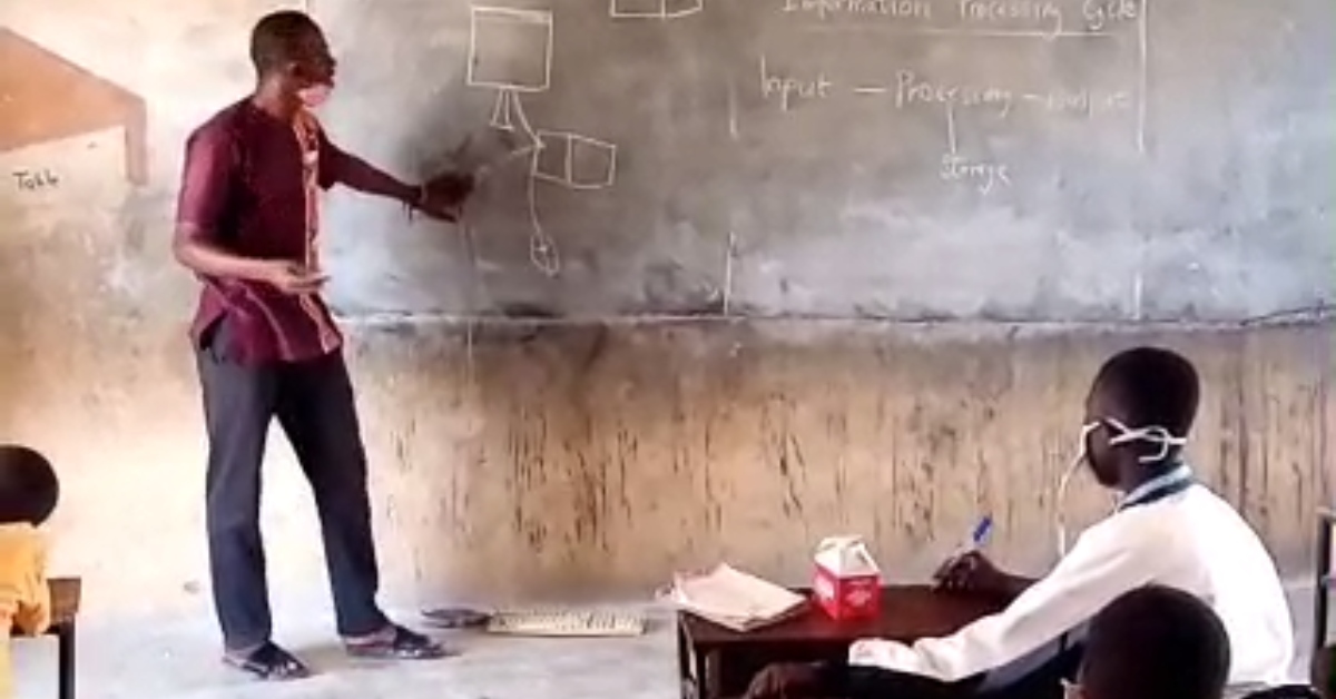 Upper East teacher connects keyboard to drawn monitor on chalkboard to teach ICT