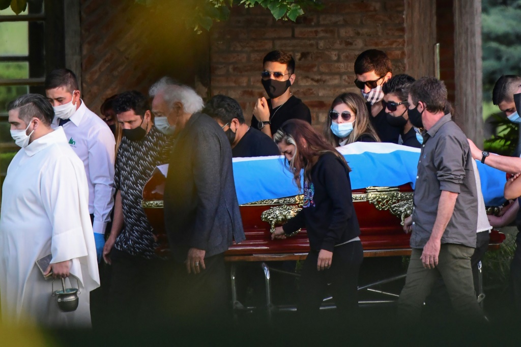 Maradona's coffin is carried by his family and friends after his death in November 2020