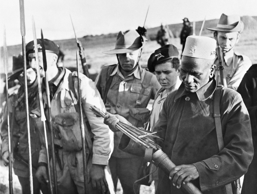 Soldiers examine spears and poisoned arrows used in the Mau Mau revolt -- one of the bloodiest episodes in British colonial rule