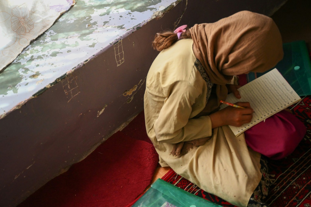 A girl studies in a secret school at an undisclosed location in Afghanistan